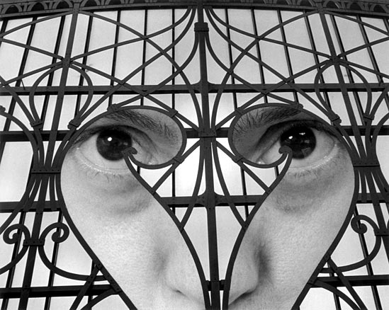 B&W curly grill work over woman's face
