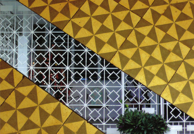Geometric tiles open to reveal white geometric gates
