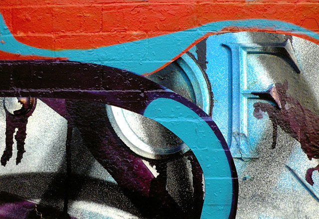 Orange and turquoise graffiti curves surround 'OF'