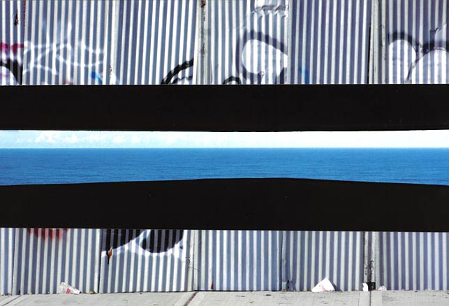 Graffiti fence with insert of ocean view, light blue water