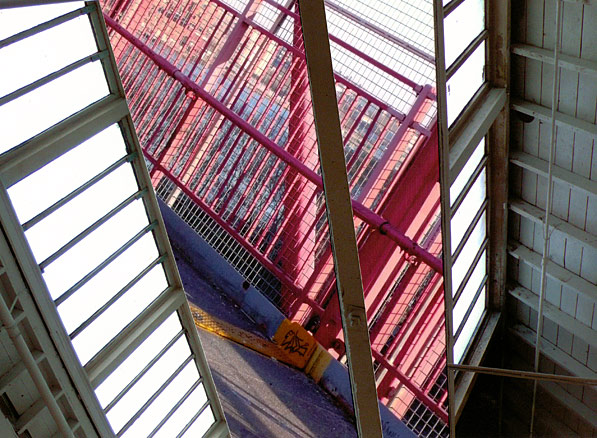 Skylights with railings on the Williamsburg Bridge, New York City White woodwork and window panes frame red railing, stripes