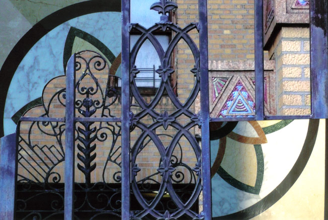 Arching metal work infront of deco brick building